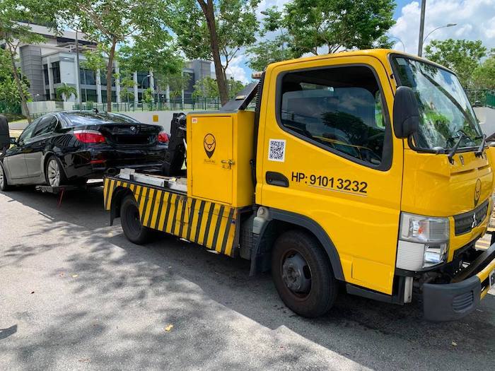 Yellow Bull Singapore Emergency Roadside Assistance tow truck towing a sedan car